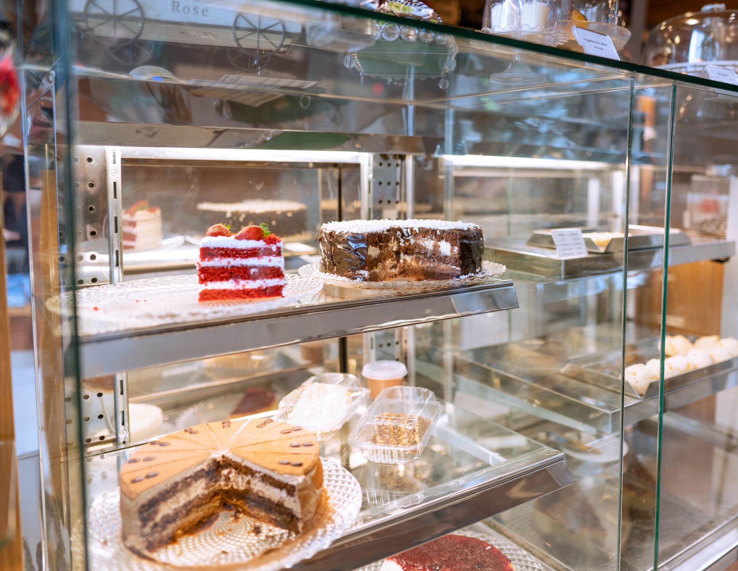 Assorted cakes and desserts in a bakery display