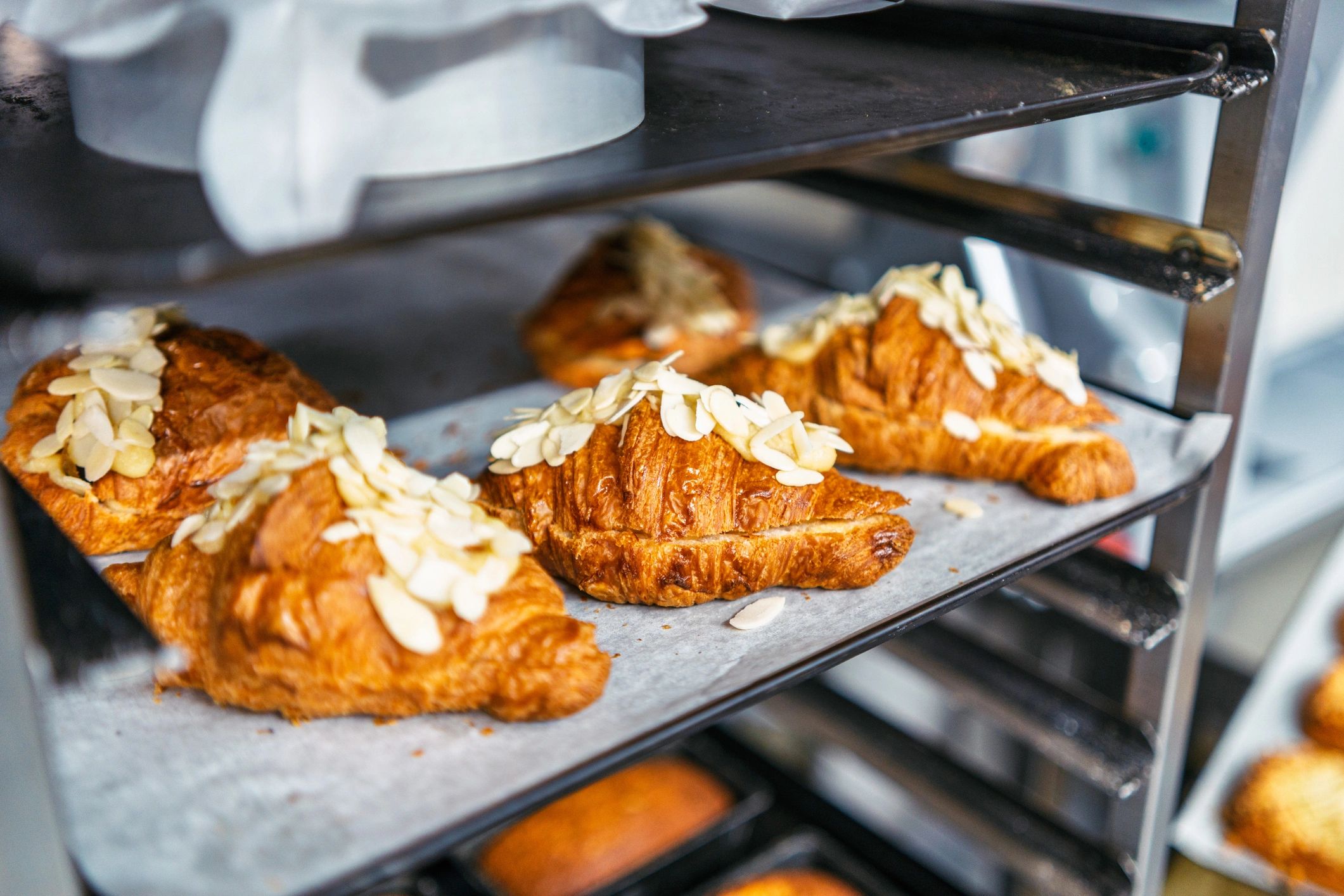 Almond croissants cooling on a rack