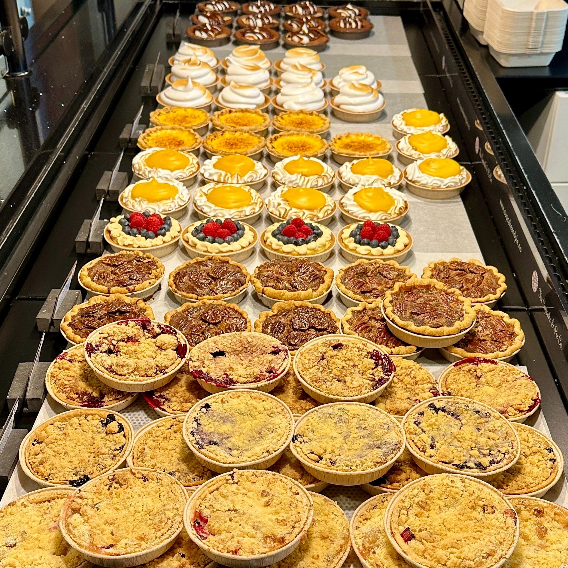 Assorted pies in a bakery display